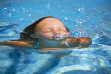 girl swimming in the swimming pool