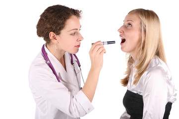 doctor examines throat in patient