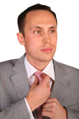 young businessman corrects  necktie