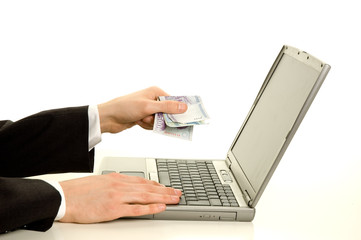 Giving cash to the computer. Online paying concept.