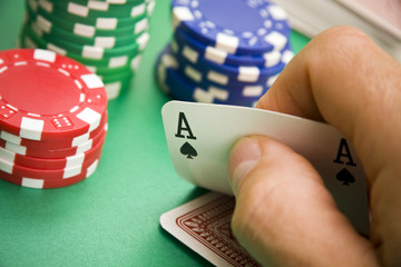 Poker player revealing ace of spades