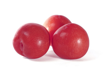 Red plums isolated on white background