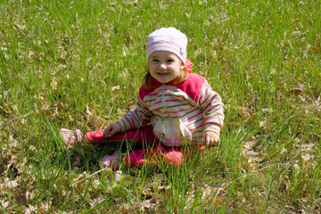 child sitting on grass
