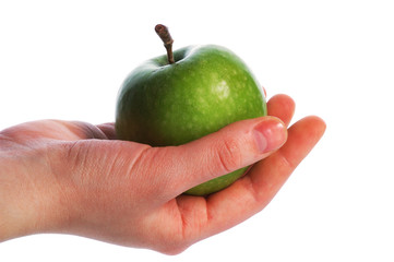 The thrown green tasty-looking apple from hand