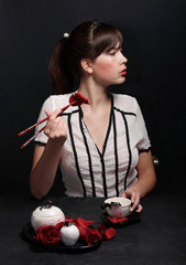 a beautiful sexy girl eats rose petals with chopsticks