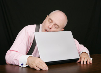 business man sleeping on his laptop