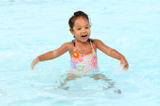 Happy young girl in a pool