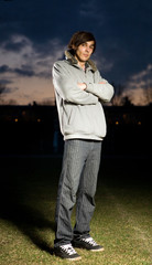 Young man standing on grass in night
