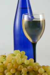 Bottle of wine, glass and grapes