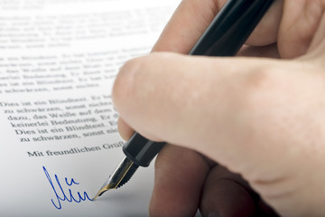 Signing letter with a pen
