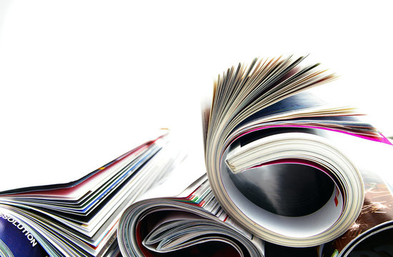 Stack of rolled up magazines, on white