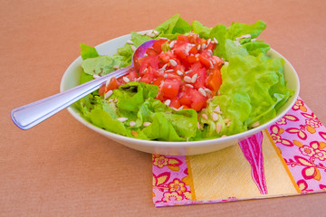 fresh green salad with tomatoes and sunflower seeds