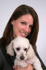 Smiling woman and her poodle dog