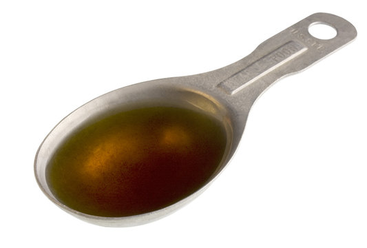 sesame oil on a measuring tablespoon