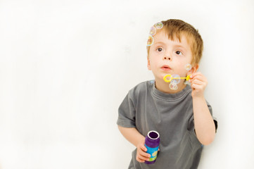 child blowing bubbles