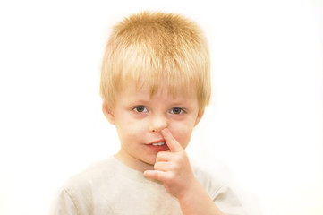 young boy picking his nose.