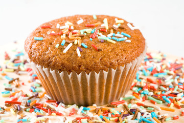 tasty muffin with colorful sprinkles, isolated