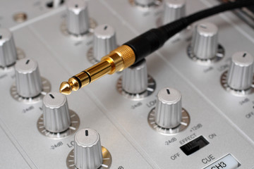 gold plug on dj music mixer