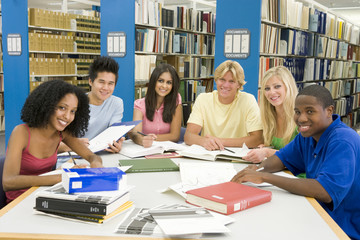 Group of university students working in library