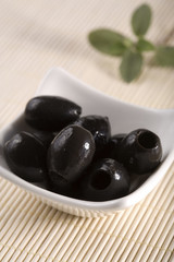 black olives without cores in white bowl