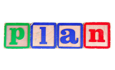 PLAN written in old wooden blocks