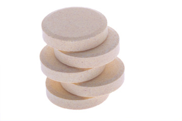 Fototapeta na wymiar stacked soluble vitamin pills on white