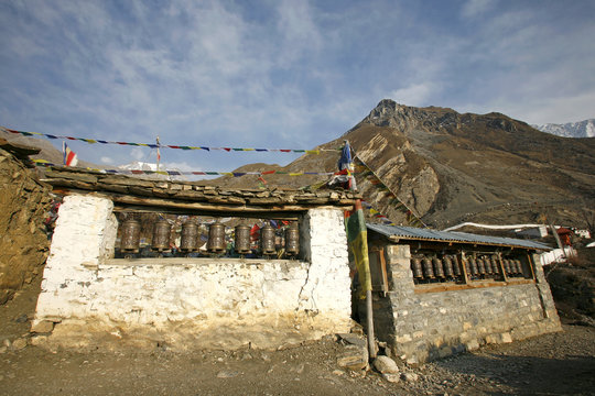 praying wheels and flags in muktinath, annapurna, nepal