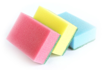 Sponges in different colors on a white surface