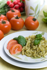 Spaghetti with pesto sauce and cheese