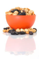 Mixed snacks in a red-orange bowl - vertical