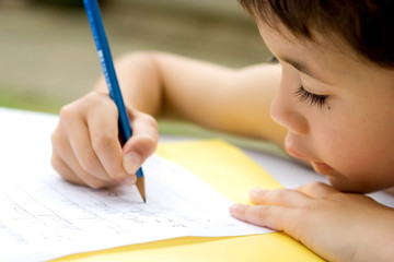  boy enjoying his his writing as part of homework, 