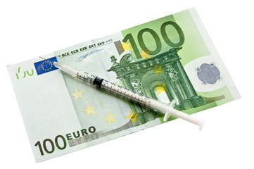 syringe lying upon european currency
