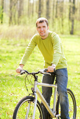 Fototapeta na wymiar Handsome young man riding a bike