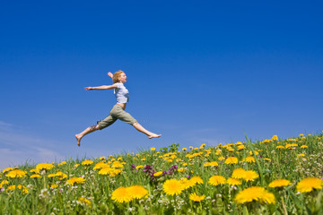 young female having fun on flowery meadow