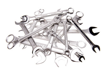 Assorted spanners over white background