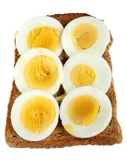 Slices of hard boiled egg on toast.