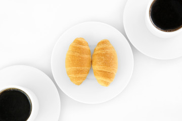 Two cup of coffe and croissants