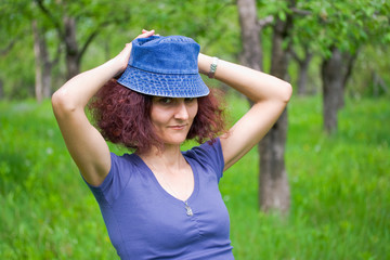 Woman with cap in an orchard