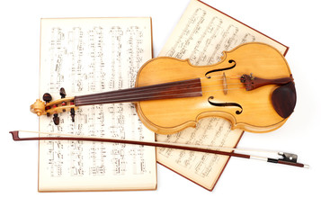Old viola, bow, and vintage music sheet
