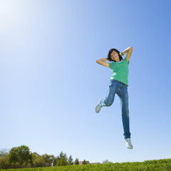 Obraz premium Happy teen jumps in air.