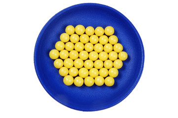 blue plateful of yellow drops vitamin