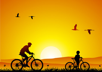 Mountain bike at sunset with child