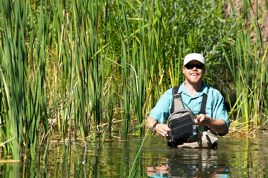 Man Flying Fishing For Trout In A Lake