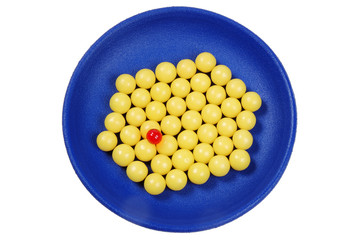 blue plateful of yellow drops vitamin and red pill