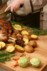 Chef cooked roasted meat and vegetables