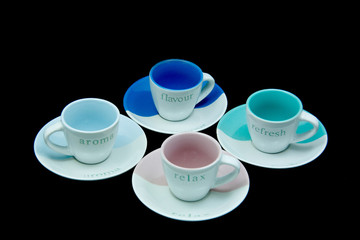 Four empty coffee cups and saucers
