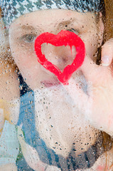 Fototapeta premium girl behind glass after a rain