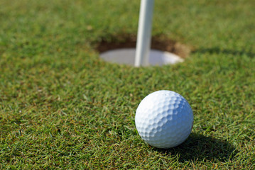 Golfball in front of the hole