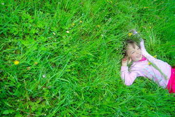 cute girl relaxing in grass