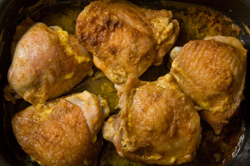 fat chicken on frying pan